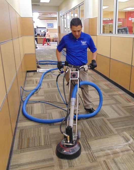 Man cleaning commercial carpet